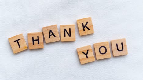 a heartwarming arrangement of letters expressing thanks set in a cozy tabletop scene filled with warmth.
