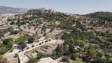 drone flying over temple of hephaestus and roman agora towards the acropolis