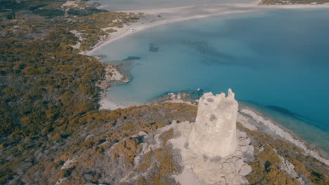 nice aerial view in orbit and close to the torre di porto giunco in cape carbonara with the beautiful beach in the background and a sunny day