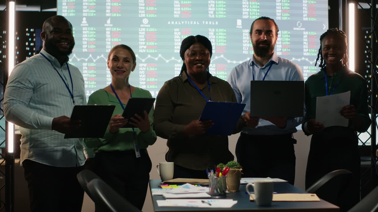 Portrait of diverse business colleagues reviewing monthly insights