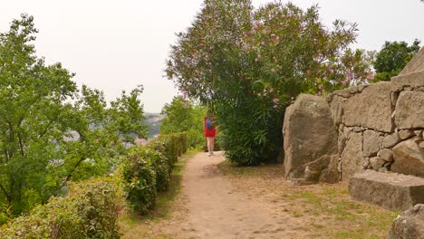 Girl-walks-on-trail-in-Jardim-das-Virtudes-in-Porto,-Portugal