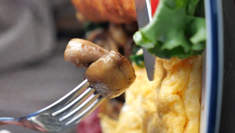 close-up of a mushroom on a fork with a meal