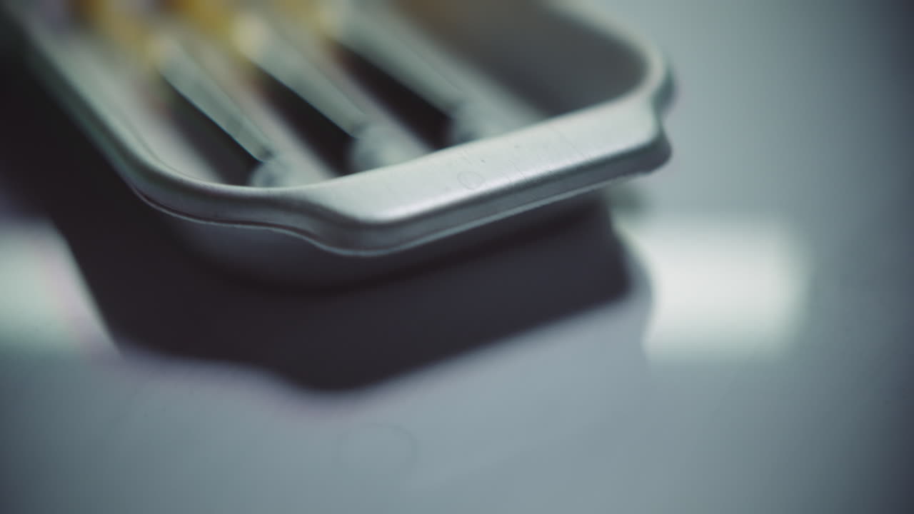 Syringes with a dark liquid on a medical tray
