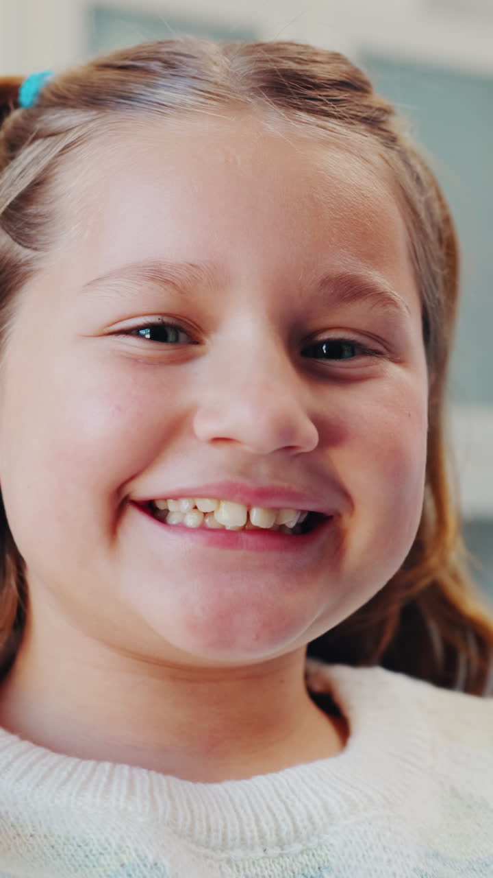 Close-up Portrait of a Happy Young Girl Smiling at the Camera