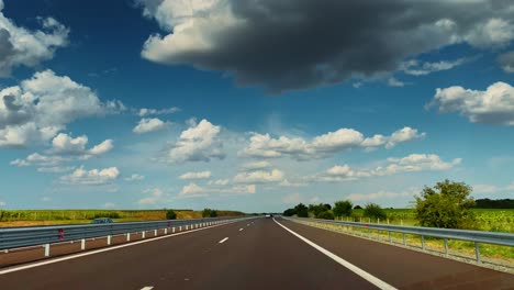 sunny green highway road in forest with blue sky