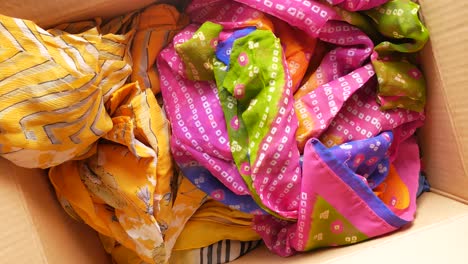 Donation-box-with-donation-clothes-on-a-wooden-background