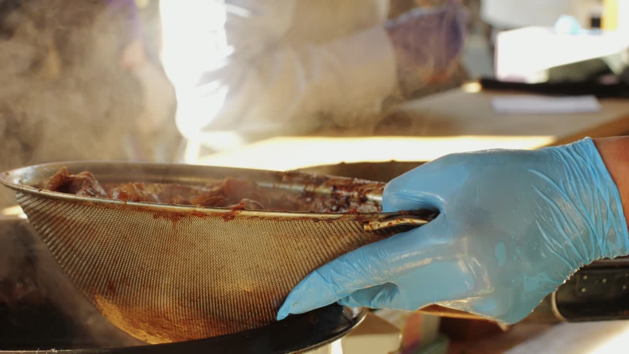 Cooking raditional chinese steamed buns Mantou in oil close-up. Mantou or bao bun with rice, green,spicies and meat. Local streetfood market outdoor. High quality 4k footage