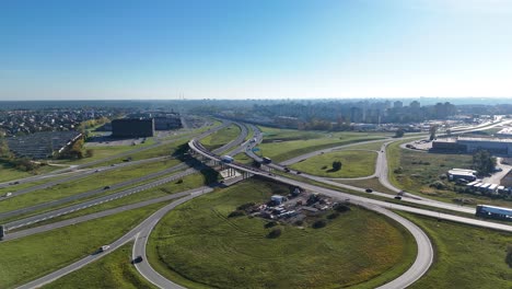 aerial view of a highway interchange connecting kaunas city with a1 and a5 motorways, infrastructure development in lithuania, drone establishing shot