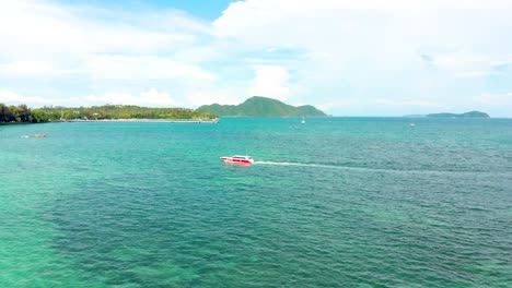 Disparo-De-Un-Dron-De-Derecha-A-Izquierda-Que-Revela-El-Resto-De-La-Playa-De-Rawai-Con-Su-Playa-De-Arena,-Aguas-Cristalinas-Y-Barcos-Anclados-A-Lo-Largo-De-La-Costa,-Ubicada-En-Phuket,-Tailandia.