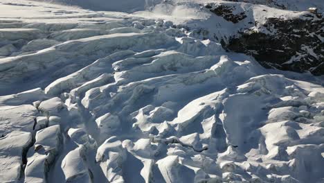 aerial panoramic: snow plain in the swiss alps in winter and a large glacier