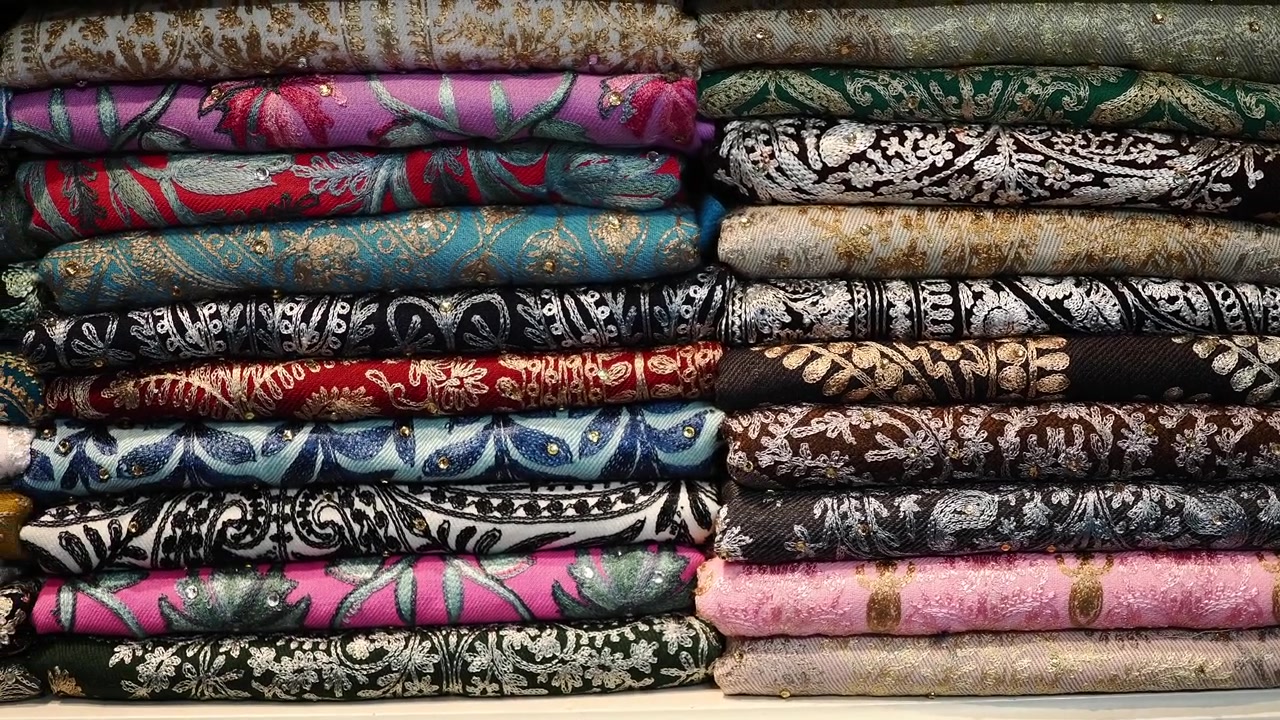 Colorful Stacked Textiles with Intricate Embroidery and Patterns