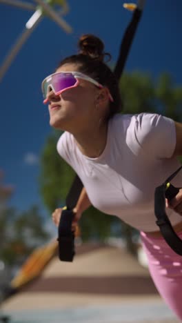 woman working out outdoors with resistance bands