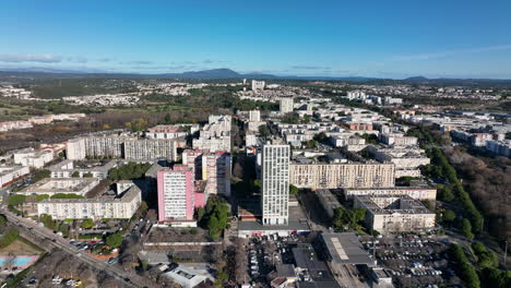 Sunny-day-flight-over-quartier-de-la-Mosson,-revealing-Montpellier's-dynamic-urb