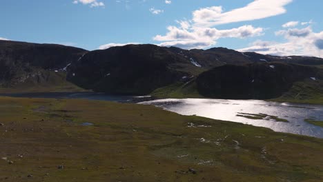 aerial view of gjende lake surrounded by scenic mountains at besseggen in innlandet, norway on a clear day