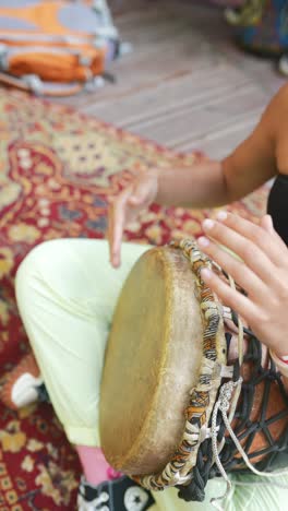 woman playing a traditional african drum