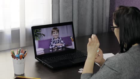 Woman-teacher-makes-video-call-on-laptop-with-children-pupil.-Distance-education