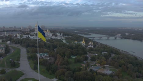 aerial view of ukrainian flag and kyiv pechersk lavra, a historic monastery in kyiv, ukraine - drone shot