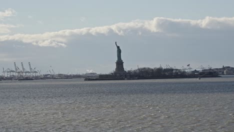 wide view of iconic statue of liberty in new york harbor, new york, usa