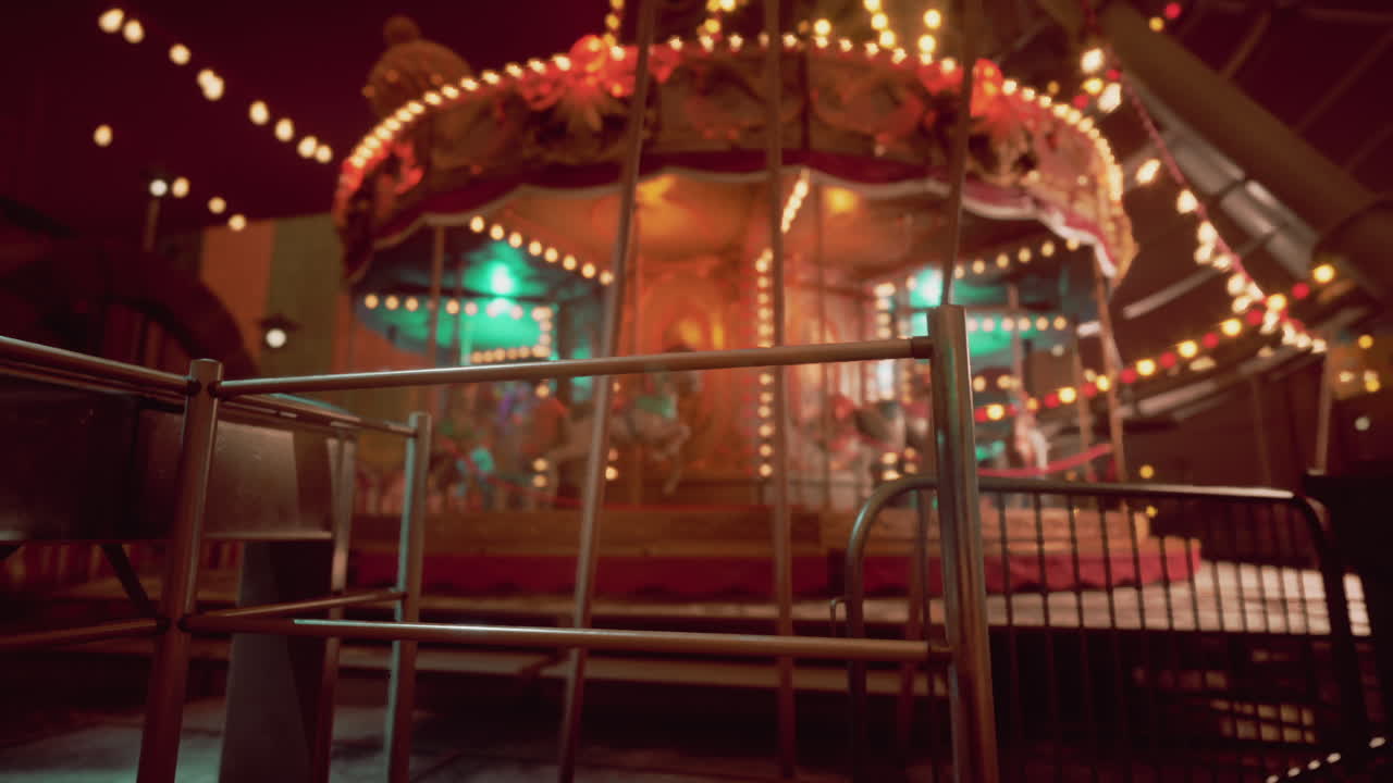 Empty amusement park at night with illuminated carousel and quiet surroundings