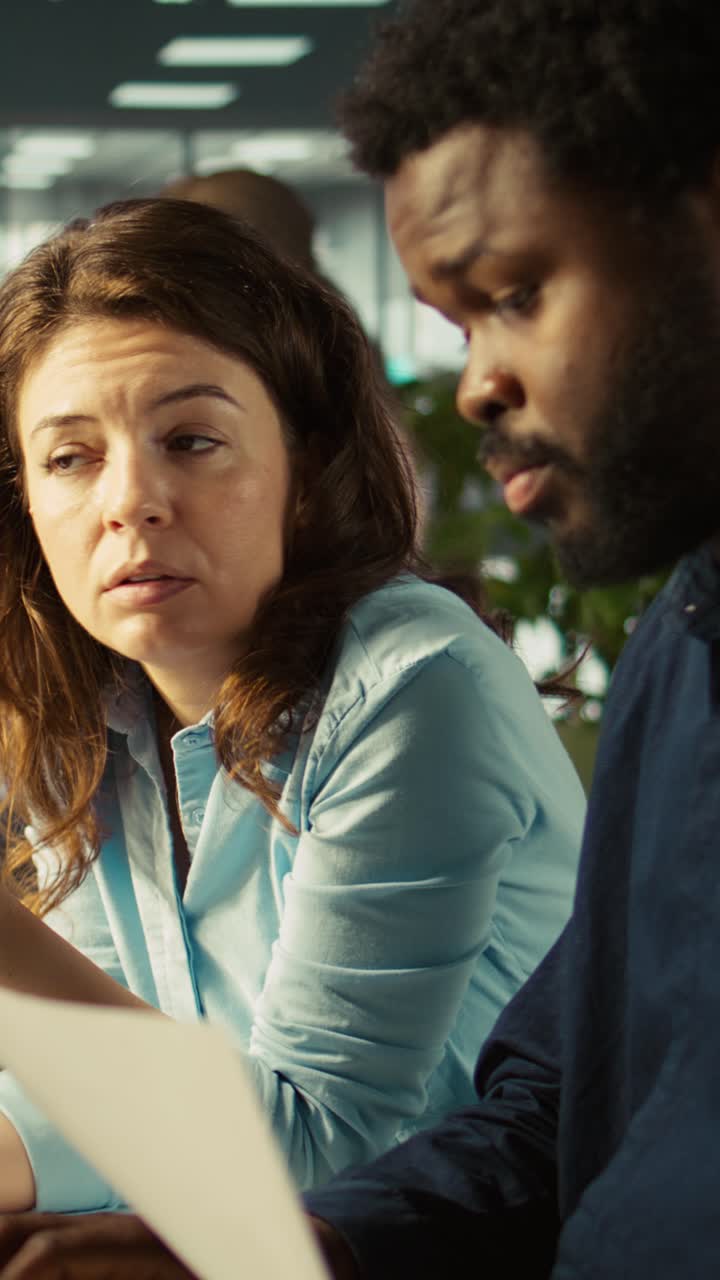 Vertical video Team leader working together with bookkeeper to verify business documents