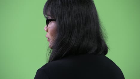 beautiful asian businesswoman looking back