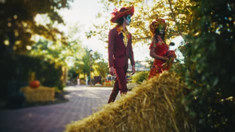 dia de los muertos couple and autumn decorations