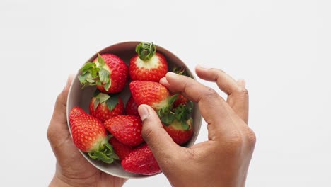 Top-view-of-hand-pick-red-strawberries-,