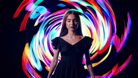 woman posing with swirling colorful light painting background