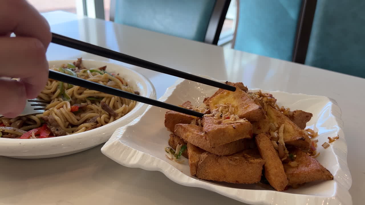 Satu porsi mi goreng dan tahu goreng dengan asap di dalam restoran Cina