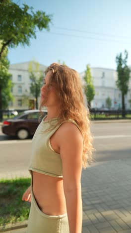 woman in a green dress on a city street