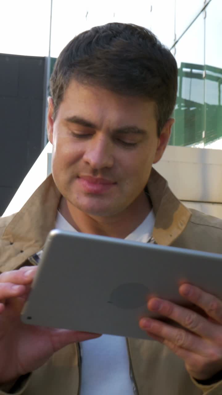 Man using a tablet outdoors