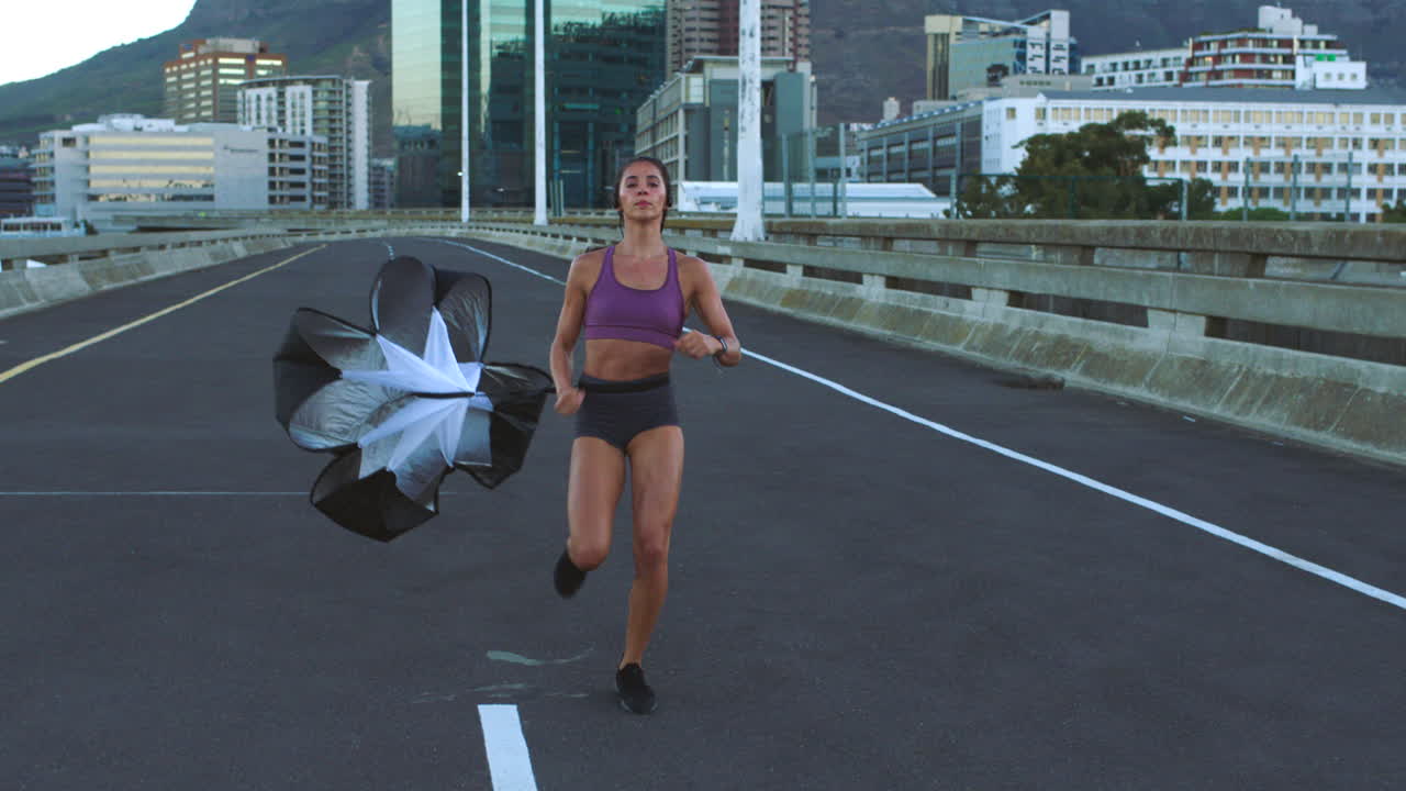 도시 다리 에서 낙하산 을 들고 달리는 여자