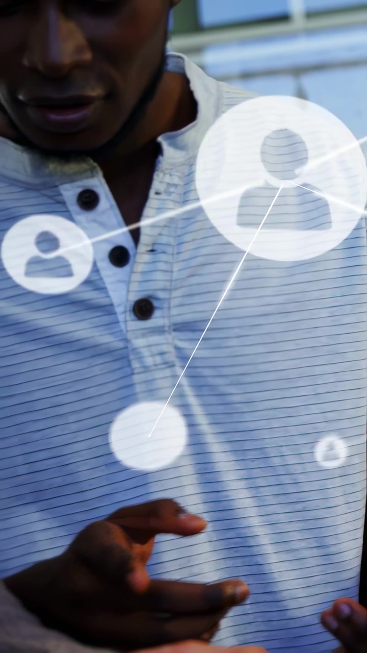 Vertical video: Man tapping phone, generating network overlay obscuring faces, tech team reviewing