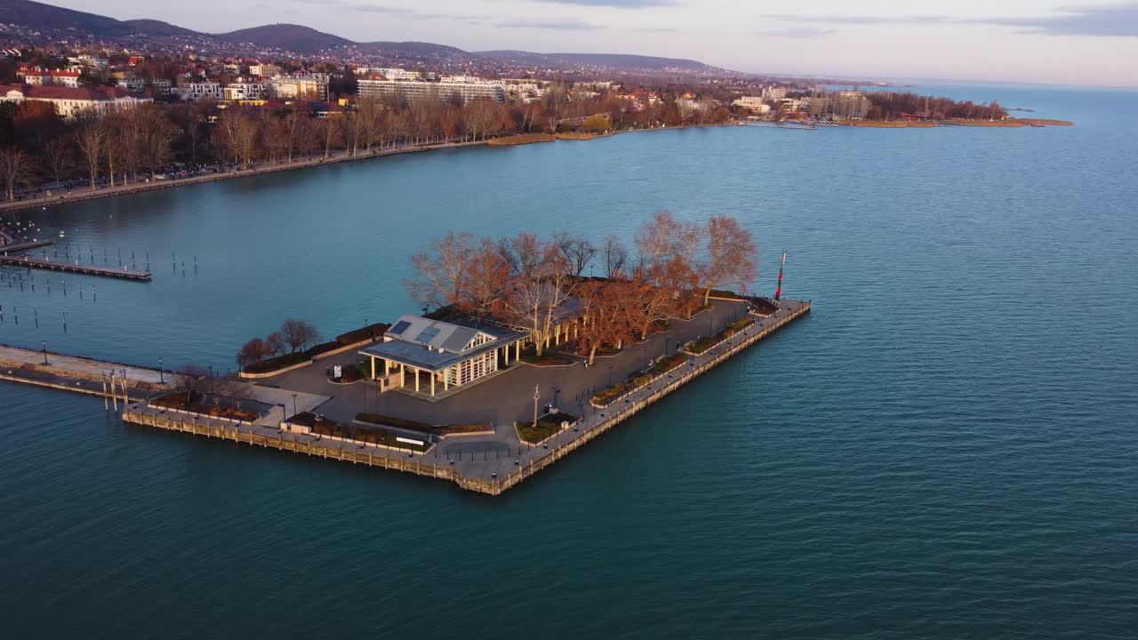 Top-down aerial of dockside island with red-roofed buildings in Balatonfured harbor area