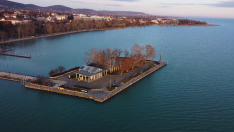 top-down aerial of dockside island with red-roofed buildings in balatonfured harbor area