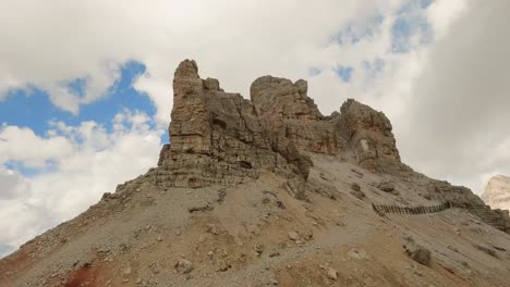 FPV-drone-soars-around-Lagazuoi-mountain-rock-formation,-capturing-its-intricate-details-from-close-range