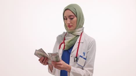 Muslim Woman Doctor Counting Money