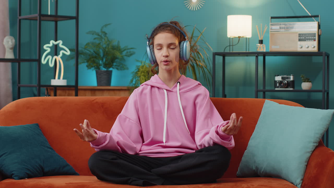 Girl breathes deeply with mudra gesture eyes closed meditating with concentrated thoughts peaceful