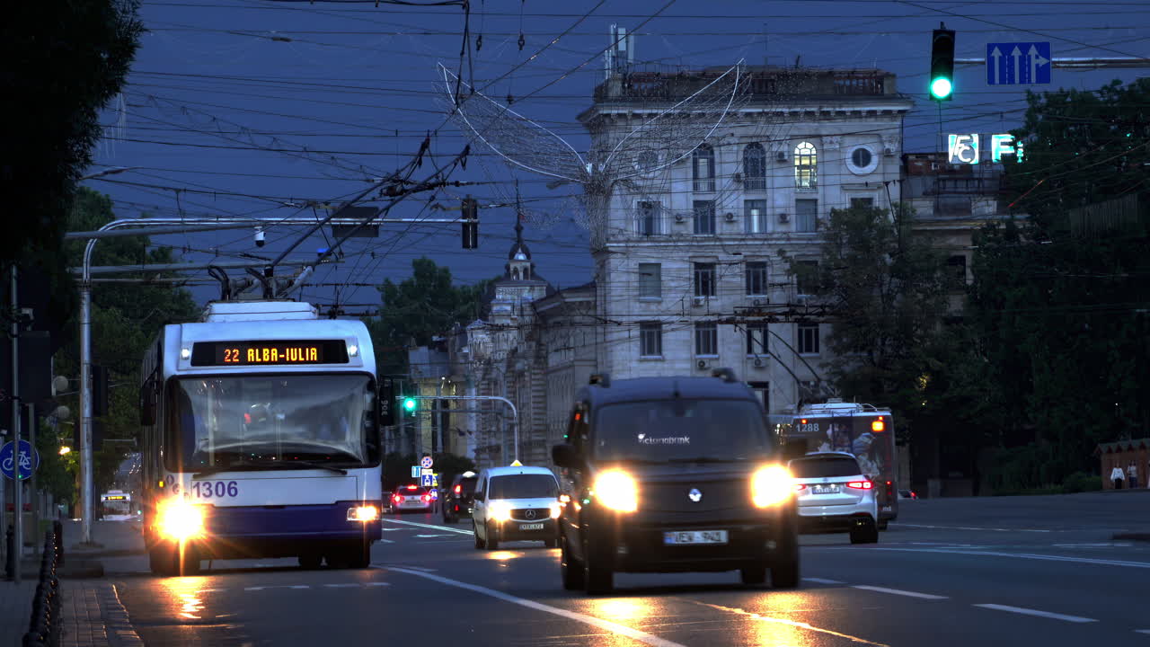 Chisinau, Moldova - June 14, 2024: Cars and public transportation moving on the streets of the city centre in the evening