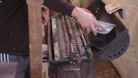 Japanese-street-pastry-with-large-steel-mold-scooping-up-freshly-made-egg-waffle