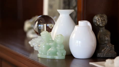 a collection of decorative objects arranged on a wooden shelf