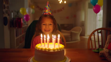 girl celebrating birthday with cake and candles