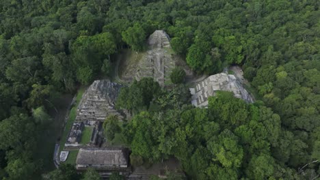 reveal shot of yaxha north acropolis maya ruins at guatemala, aerial