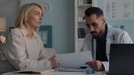 doctor discussing medical report with patient