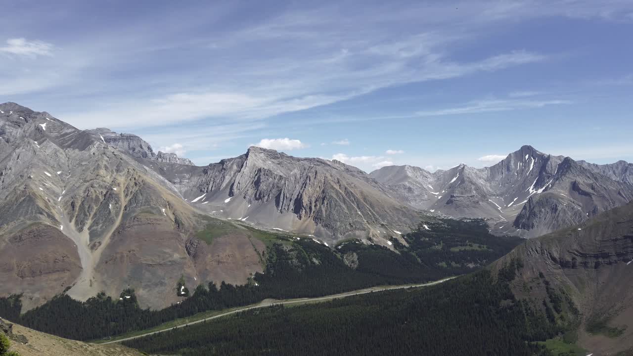 Pegunungan dengan jalan yang membentang jauh pada hari yang cerah, Pegunungan Rocky, Kananaskis, Alberta, Kanada.