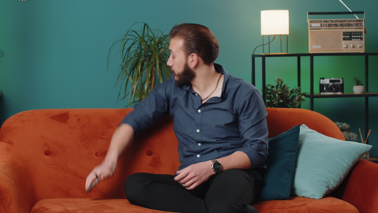 Repair work at neighbours concept irritated man at home cover ears with pillows annoyed by noise