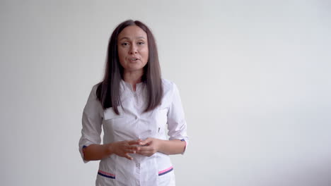 female doctor talking to camera with a white background and copy space