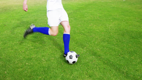 Jugador-De-Fútbol-Pateando-Una-Pelota-En-El-Campo