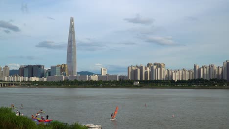 wind surfing, kayaking and paddle boarding in the seokchong lake in seoul, south korea