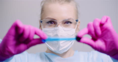 Working-In-Lab-Scientist-Holding-Test-Tubes-Positive-Test-Of-Covid-19-Coronavirus-At-Laboratory-3